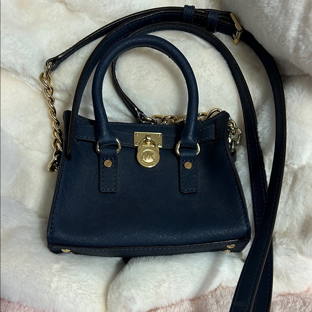 Michael Kors Navy Blue Leather Handbag with Gold accents and hardware.